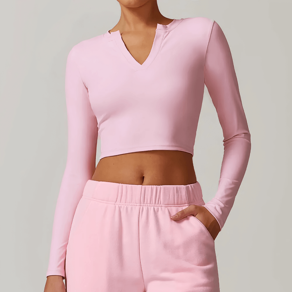 V-Neck Yoga Long Sleeve Crop Top for Women in soft pink, perfect for fitness and yoga, featuring breathable and quick-dry fabric.