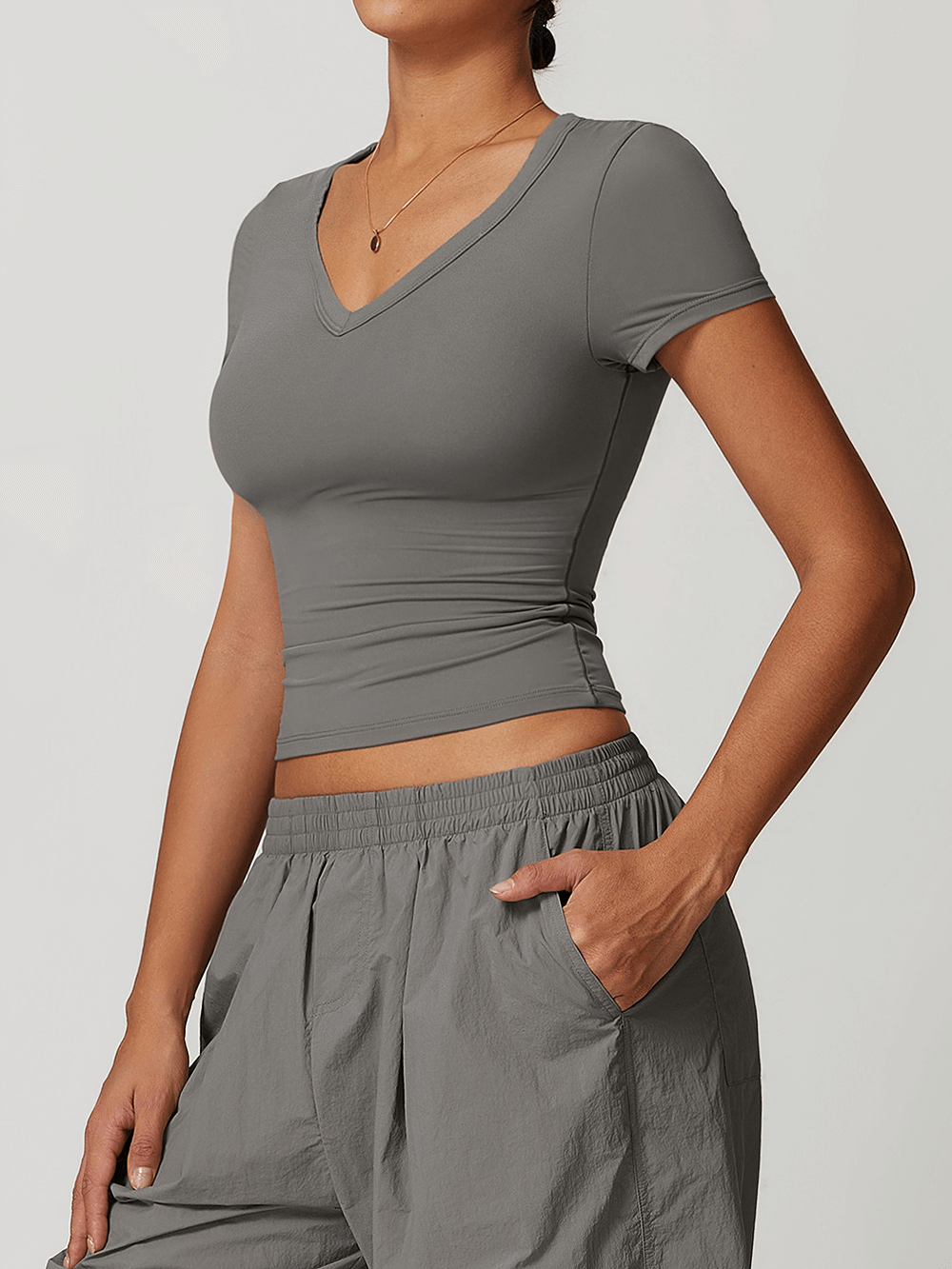 Women's V-Neck Yoga Tee in gray, perfect for fitness enthusiasts. Breathable and quick-drying, ideal for yoga and workouts.