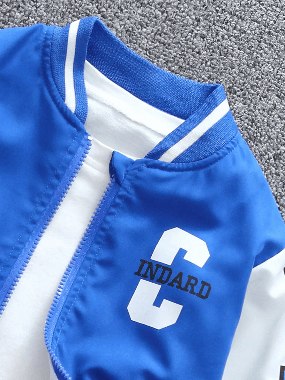 Blue varsity bomber jacket with bold 'C' graphic and zip-up design for stylish kids. SF3114