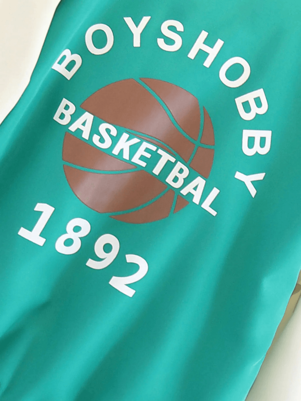 Teal varsity style children's basketball jacket with brown basketball graphic, sporty and trendy design, SF3116