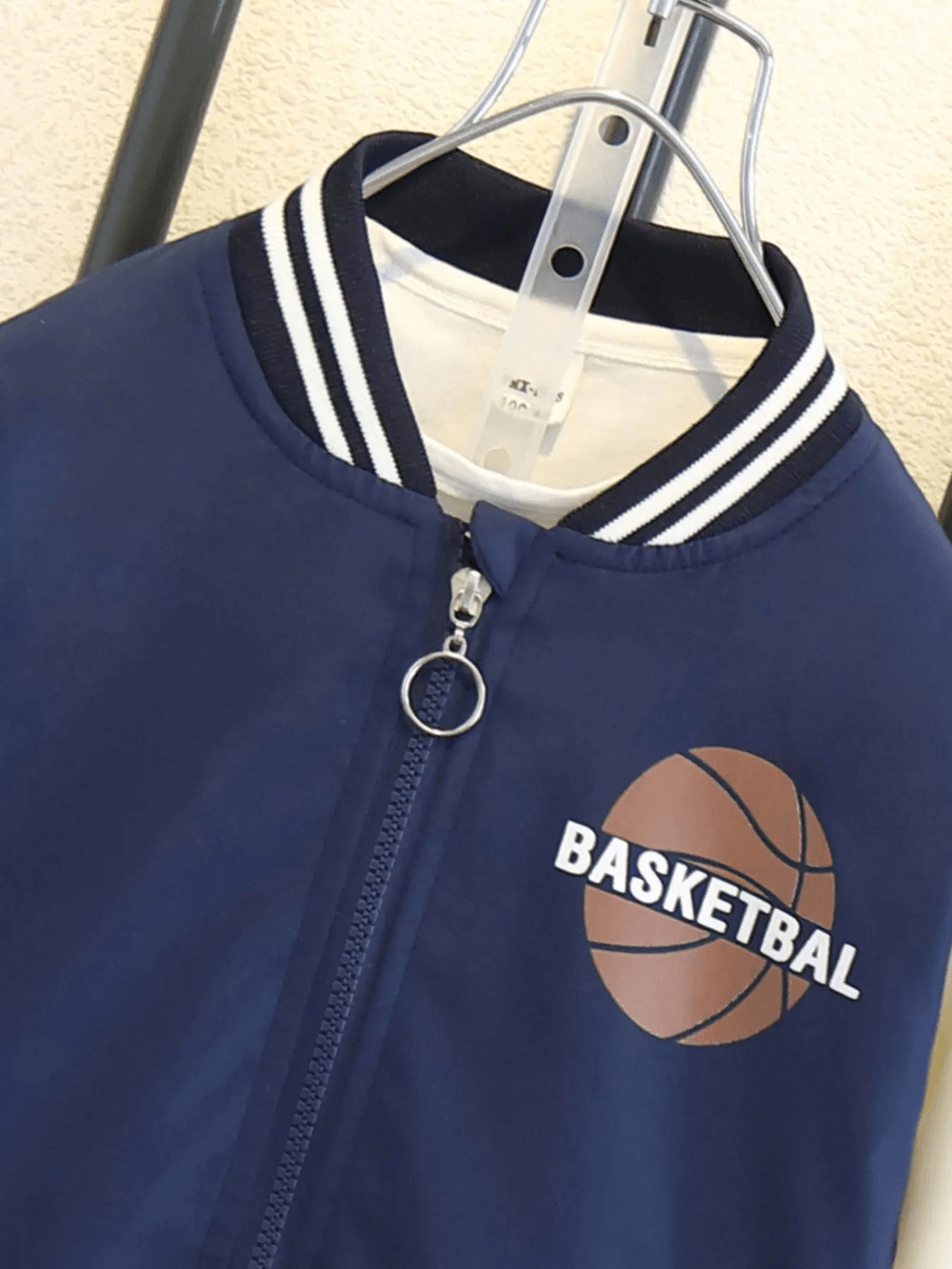 Children's varsity basketball jacket with basketball graphic, zip-up closure, and ribbed collar.