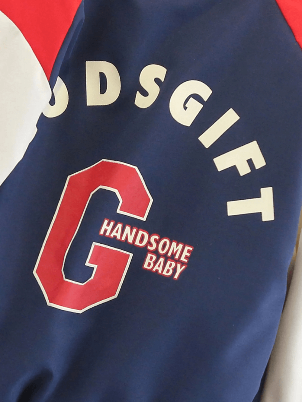 Navy and red kids varsity jacket with bold 'G' and 'HANDsome Baby' print, perfect for casual autumn outings and sporty style.