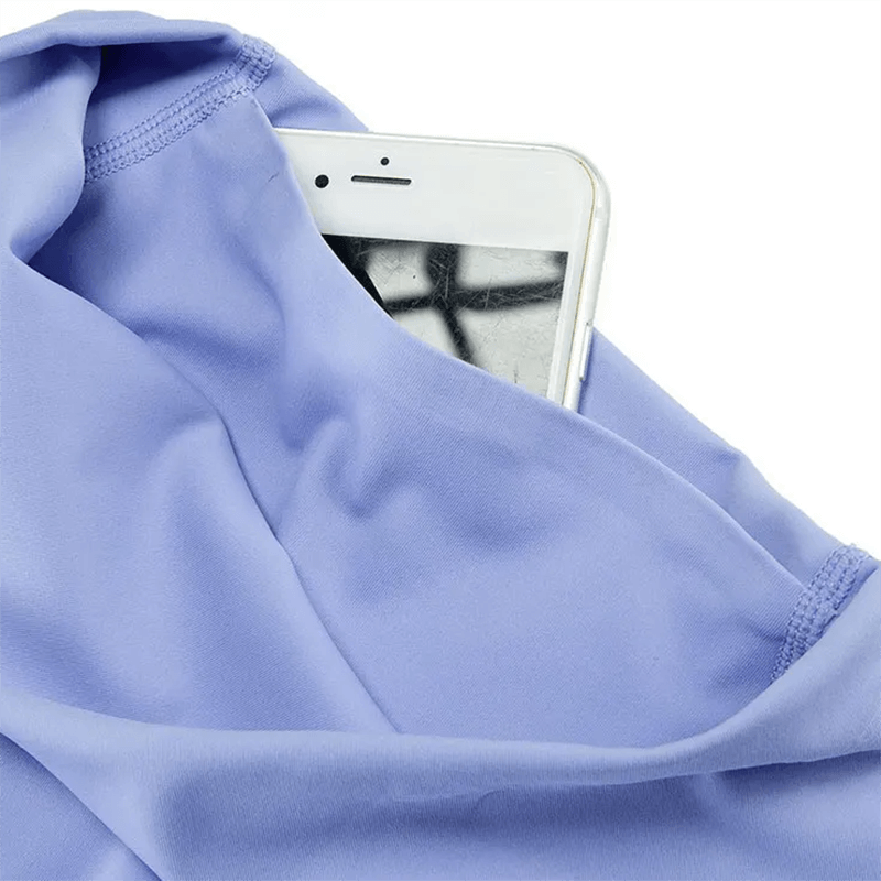 Close-up of purple activewear fabric with a smartphone in the pocket, showcasing breathable and quick-dry material.