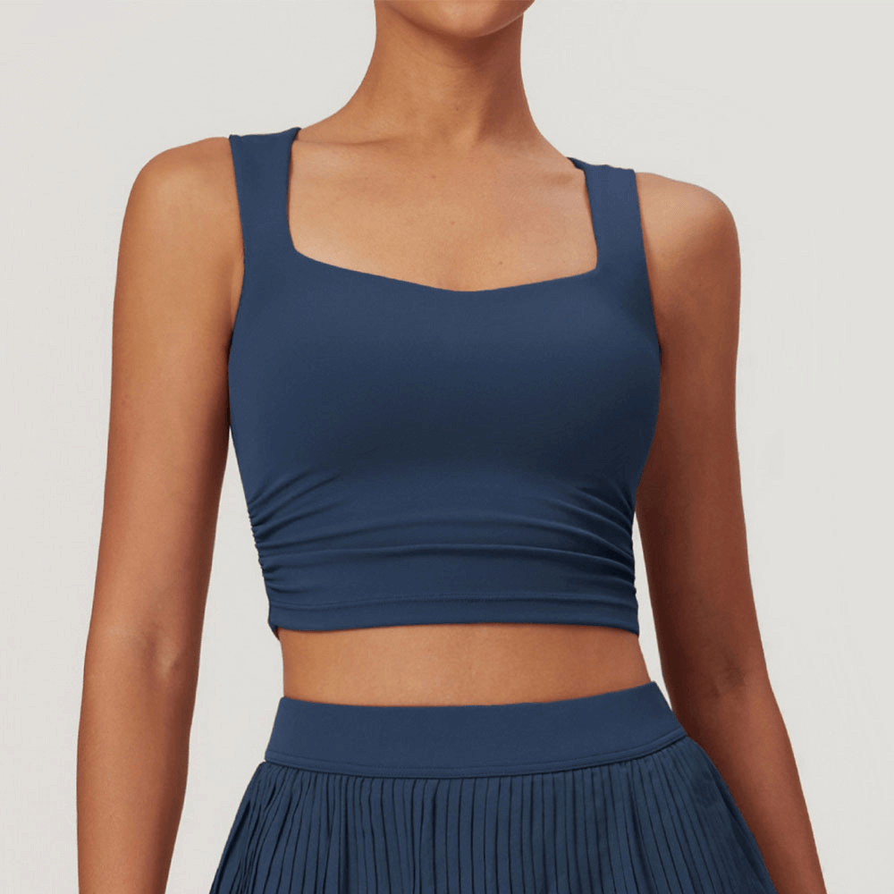 Women's blue versatile workout crop tank top for fitness, sleek and solid design, perfect for running, cycling and dancing.