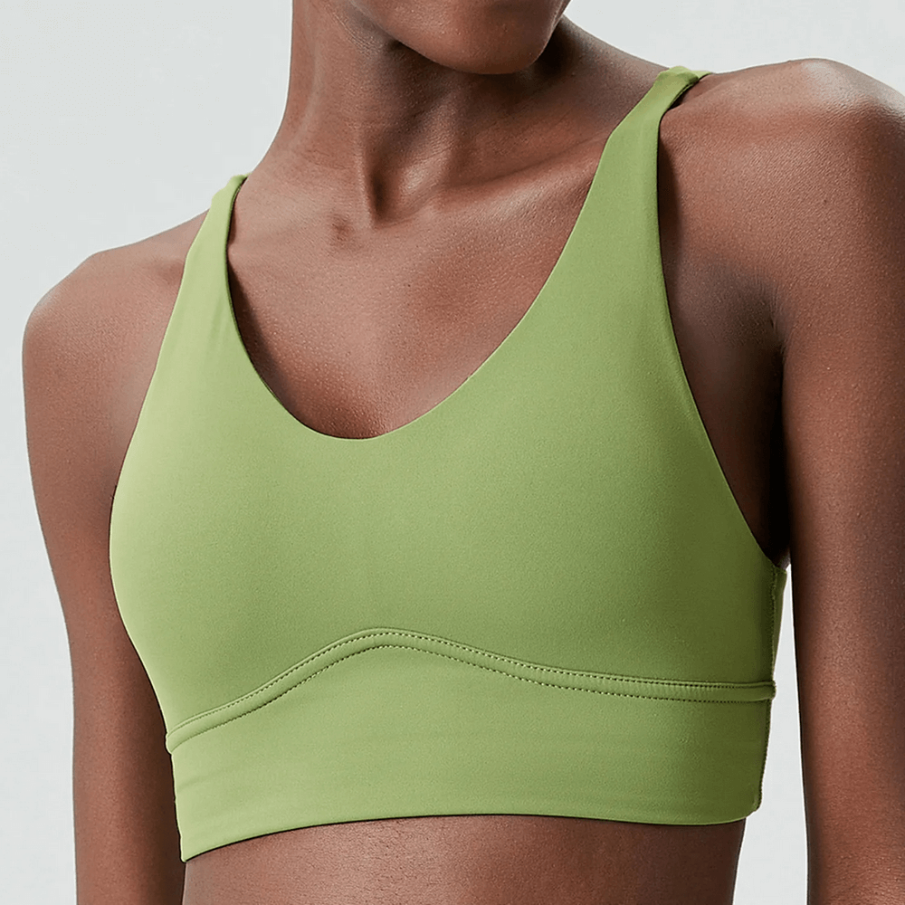 Green sports bra with a sleek design and cross-back straps, perfect for workouts.