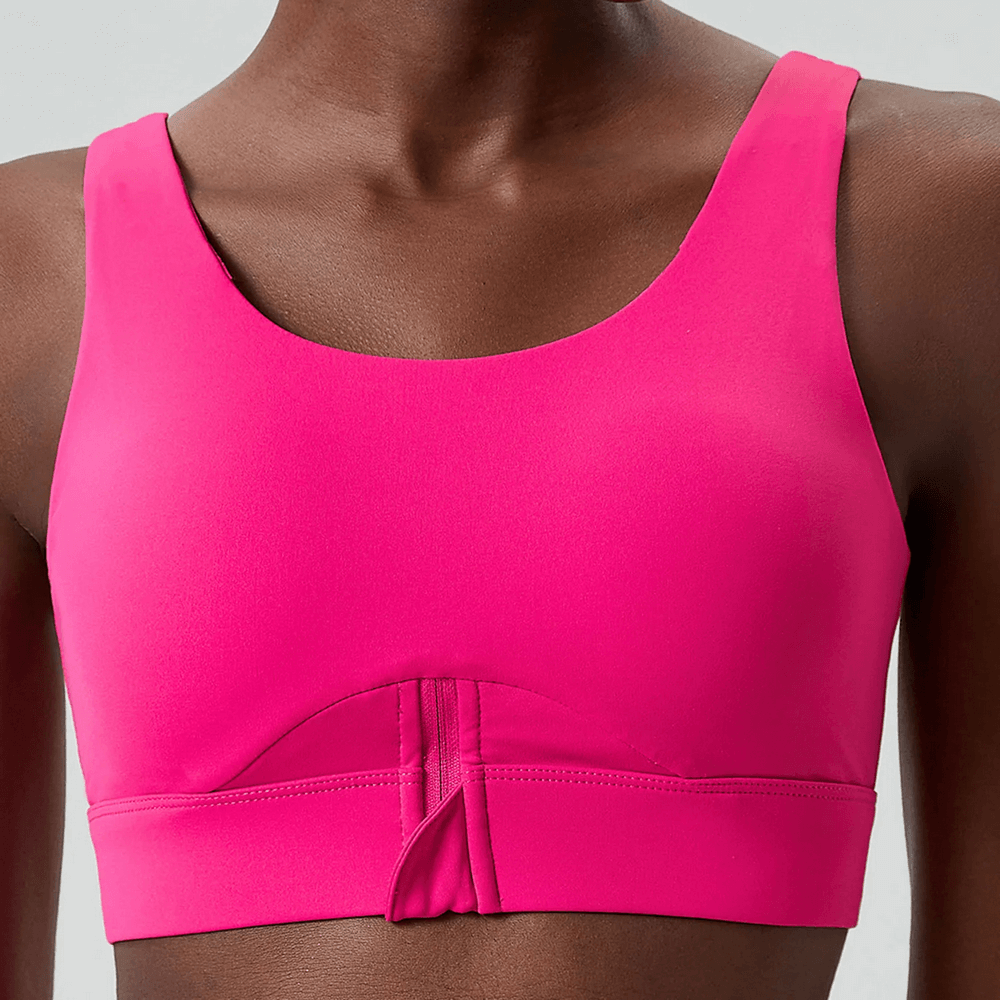 Vibrant pink yoga fitness bra featuring a solid color design, half-zipper, and breathable fabric for high-impact workouts.