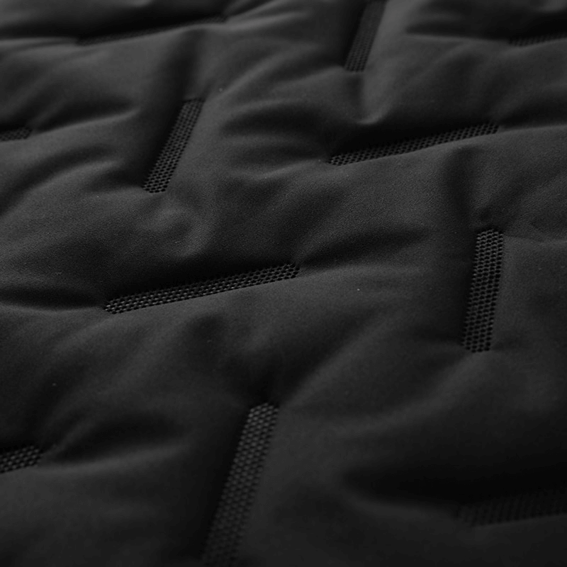 Close-up of a textured black fabric with geometric patterns, showcasing a stylish and modern design.