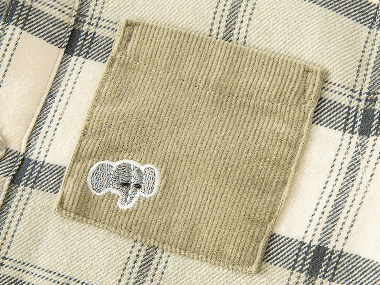 Close-up of pocket detail on Warm Cotton Plaid Long Sleeves Shirt with Pocket - SF3517 for kids with elephant embroidery