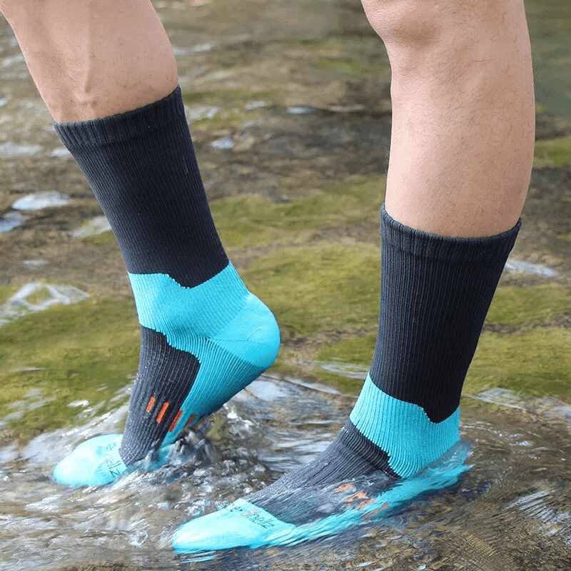 Feet wearing warm waterproof high socks SF1628 standing in water, showcasing durability and performance for hiking and camping.