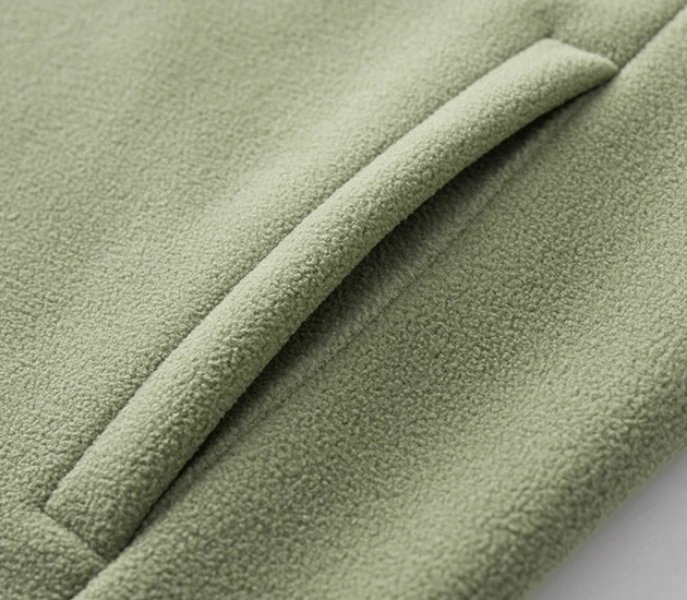 Close-up of a green fleece jacket pocket highlighting soft fabric, stylish design, and practical storage for the SF1889 unisex sports jacket.