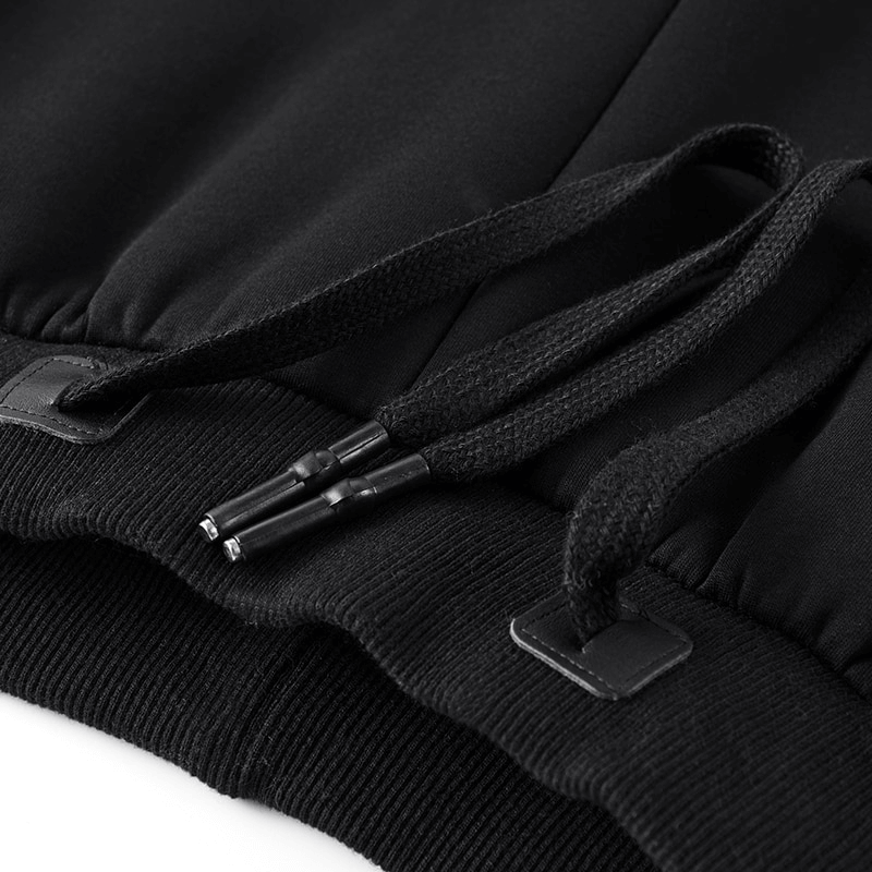 Close-up of black joggers with drawstring and ribbed cuffs, highlighting comfort and style for men's casual wear.