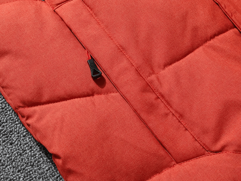 Close-up of warm, windproof, waterproof ski suit fabric with zipper detail; ideal for outdoor sports and winter activities.