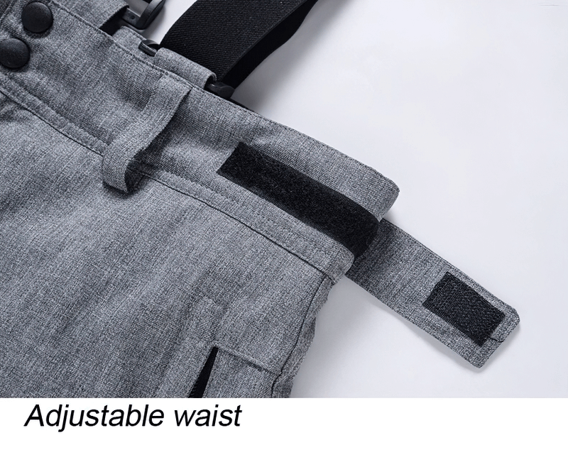 Close-up of adjustable waist feature on ski suit, showcasing grey fabric and velcro strap, perfect for a customized fit.