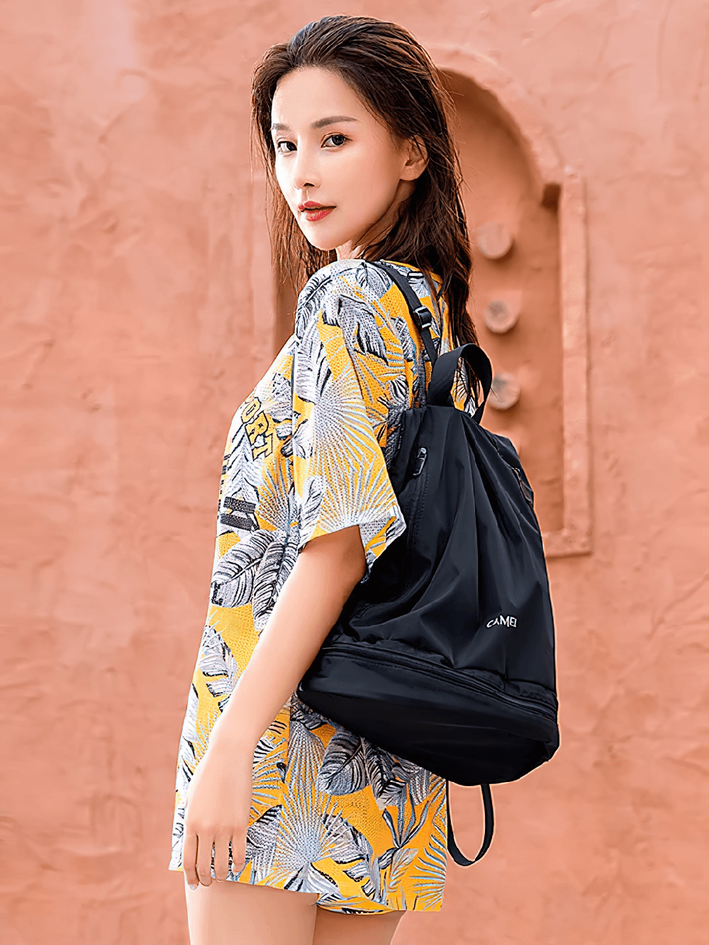 Young woman wearing waterproof backpack SF2293, perfect for gym and outdoor activities, featuring dry and wet separation storage.