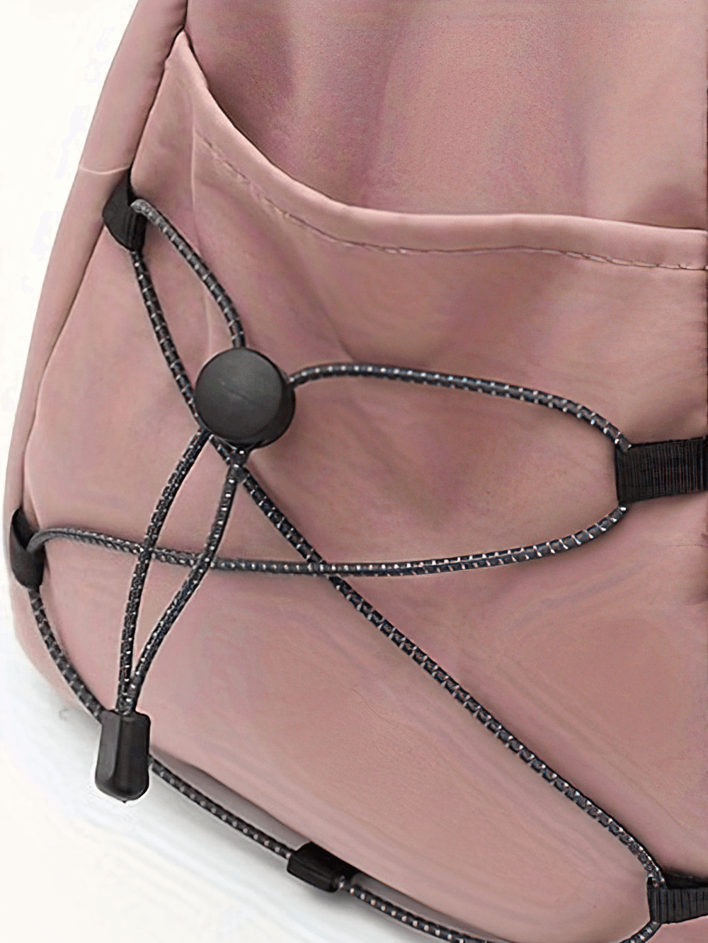 Close-up of pink waterproof fitness bag showing zip closure and black cords on side, ideal for gym and travel.