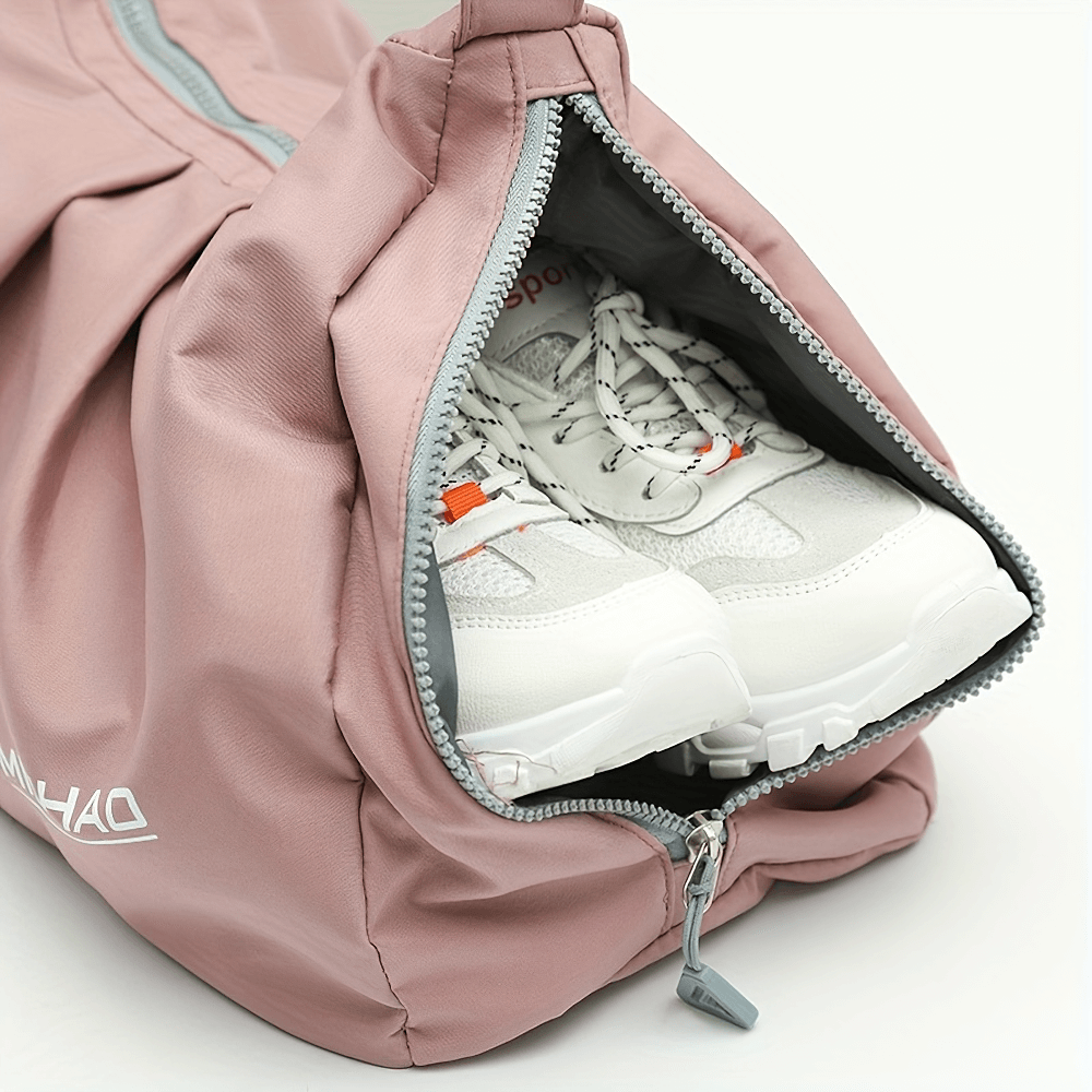 Pink waterproof fitness bag with sports shoes in dry compartment, ideal for gym and travel. Durable Oxford material with zip closure.