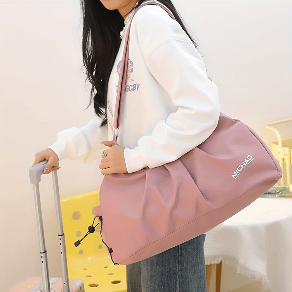 Woman holds pink waterproof fitness bag SF2657 with zip closure, ideal for gym and travel. Made from durable Oxford material.