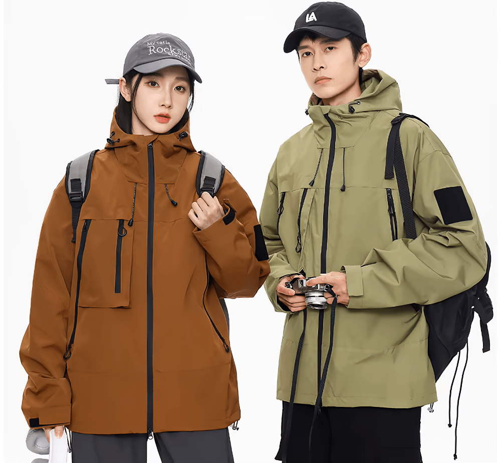 Two models wearing waterproof hiking jackets with hoods and pockets, perfect for outdoor activities like camping and cycling.