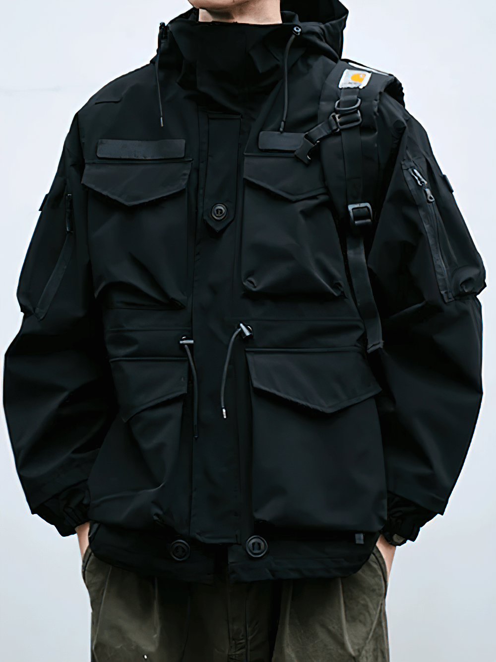 Person wearing a waterproof hooded jacket with multiple pockets, SF2262 model. Perfect for extreme outdoor conditions.