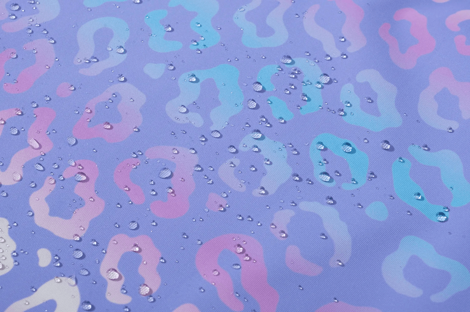 Close-up of Waterproof Hooded Jacket with Pastel Leopard Print - SF3570 fabric detail with water droplets.