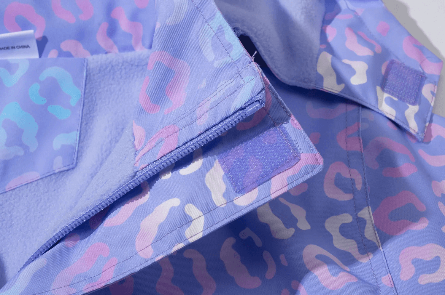 Close-up of Waterproof Hooded Jacket with Pastel Leopard Print - SF3570 showcasing fabric texture and print details.