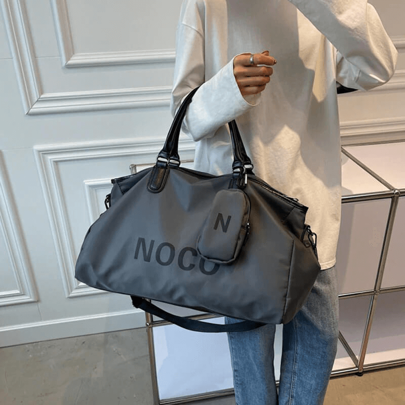 Unisex waterproof large shoulder bag in gray, perfect for fitness and travel, made of quality nylon with black handles.