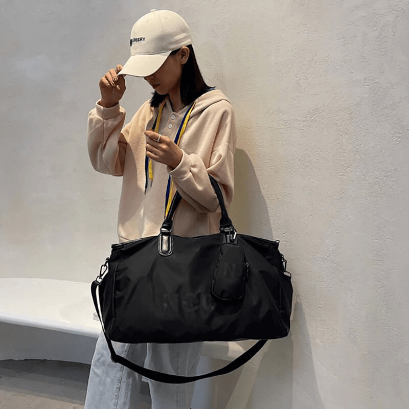 Person holding a stylish waterproof large shoulder bag SF0234, perfect for unisex sports and fitness needs.