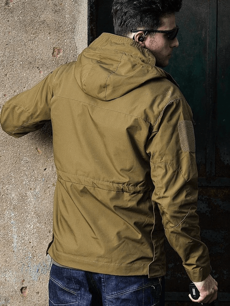 Man wearing waterproof men's windbreaker with hood and pockets SF1871, perfect for outdoor activities like biking and hiking.
