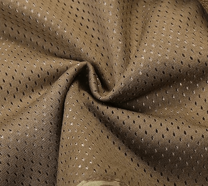 Close-up of waterproof windbreaker fabric in brown, featuring breathable perforations for outdoor comfort.