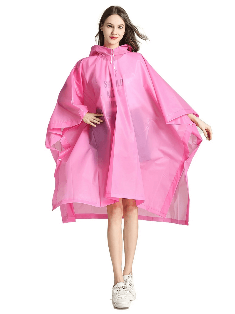 Woman wearing a pink transparent waterproof raincoat, showcasing stylish and durable protection from the elements, perfect for any weather.