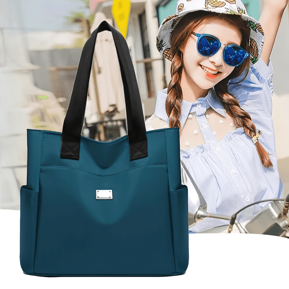 Fashionable waterproof shoulder bag in teal with multi-pocket design perfect for daily use, displayed with a smiling woman in background.