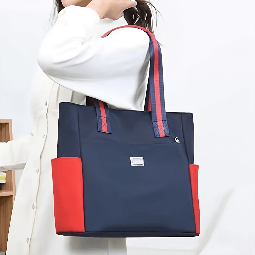 Stylish waterproof navy shoulder bag with red accents, multi-pocket design, perfect for daily use, work, or travel.