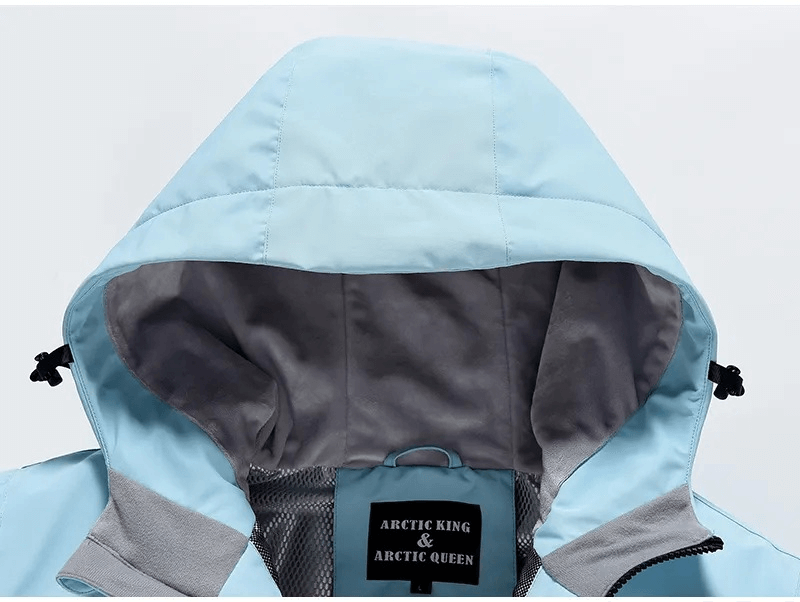 Light blue waterproof ski jacket with hood, detailed view showing adjustable toggles and soft inner lining, ideal for winter sports.