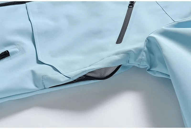 Close-up of blue waterproof ski jacket SF1807 showing side pocket and zipper details for men and women.