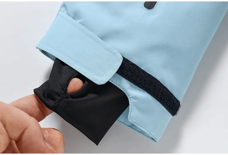 Close-up of unisex waterproof ski jacket cuff with thumbhole, showcasing blue polyester fabric with secure Velcro strap, SF1807 design.