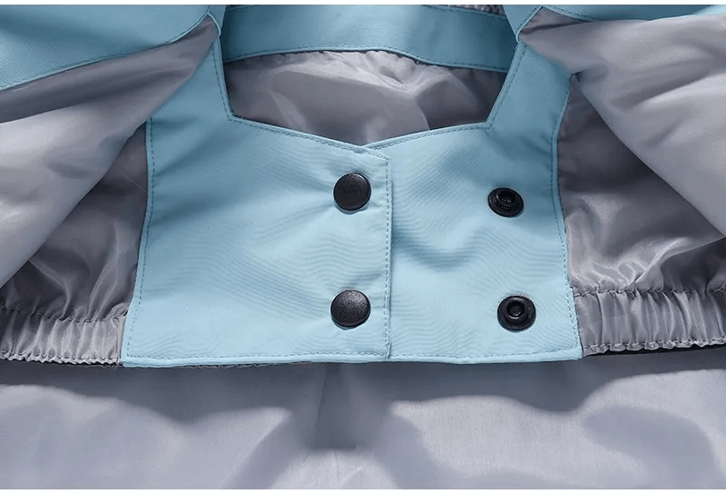 Close-up of blue waterproof ski jacket hood lining and button details, ideal for men's and women's outdoor winter activities.