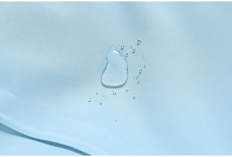 Water droplet on blue waterproof fabric, showcasing durability and resistance in unisex ski jacket SF1807. Perfect for winter sports.