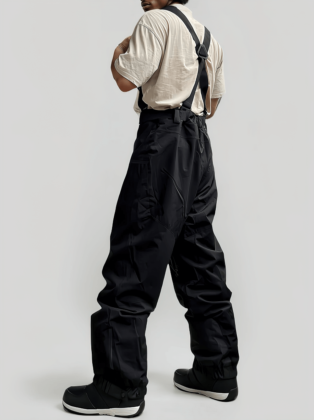 Man wearing waterproof ski pants with adjustable suspenders - SF4272, showcasing durable snow gear with reinforced cuffs and zipper pockets.