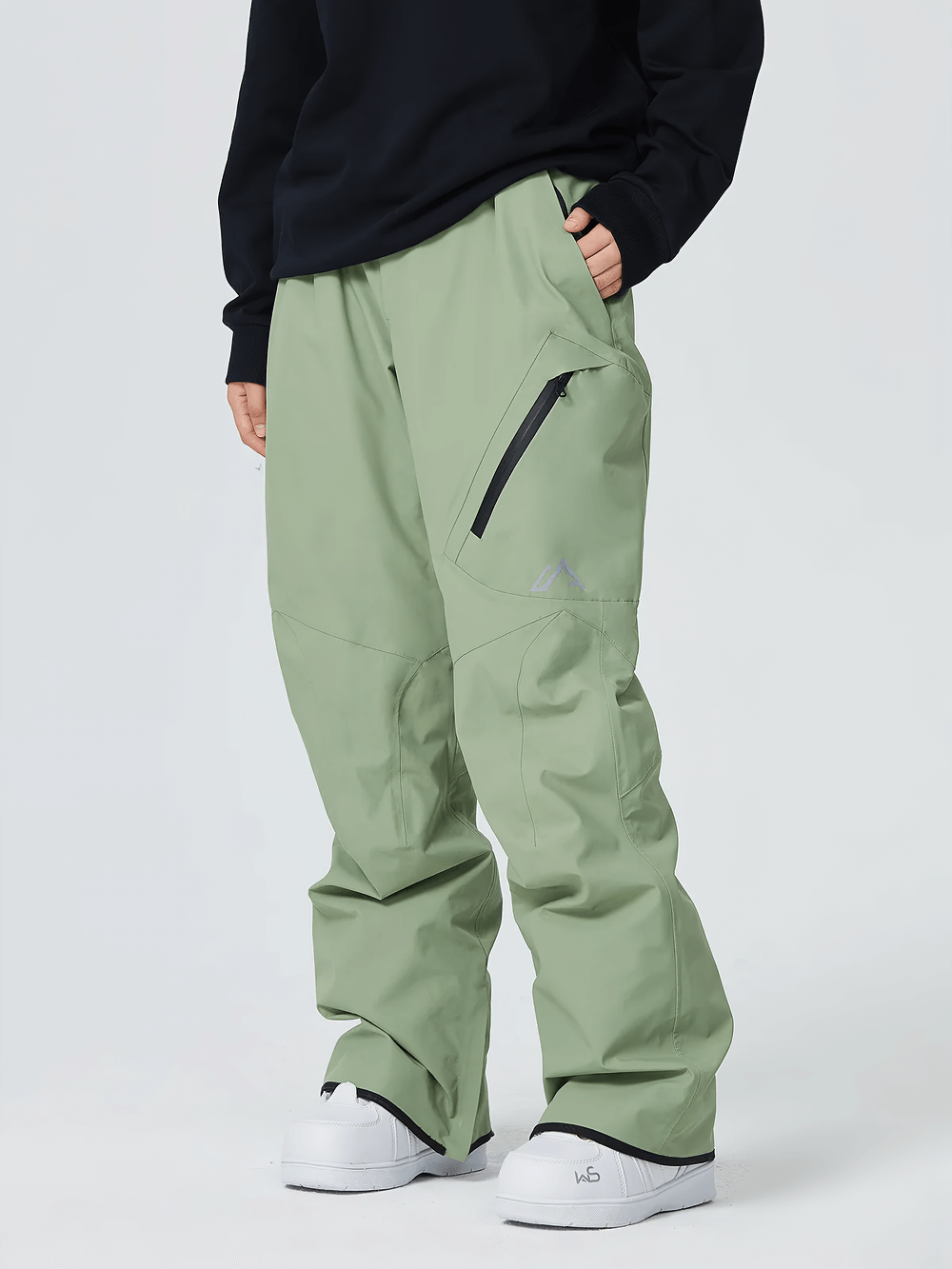 Person wearing durable and stylish waterproof snowboard pants with utility pockets, showcasing wind-resistant fabric and reinforced seams.