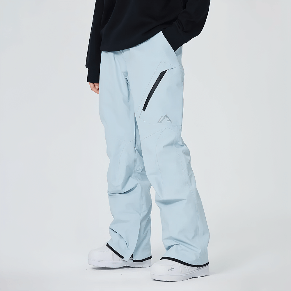 Person wearing light blue waterproof snowboard pants with utility pockets and zippered leg openings for outdoor sports.