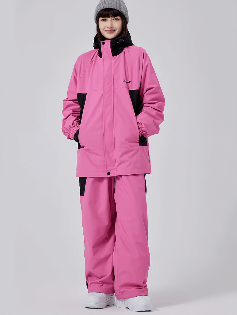 Woman wearing pink waterproof snowboarding jacket and pants set, SF2471; thermal and windproof for winter adventures.