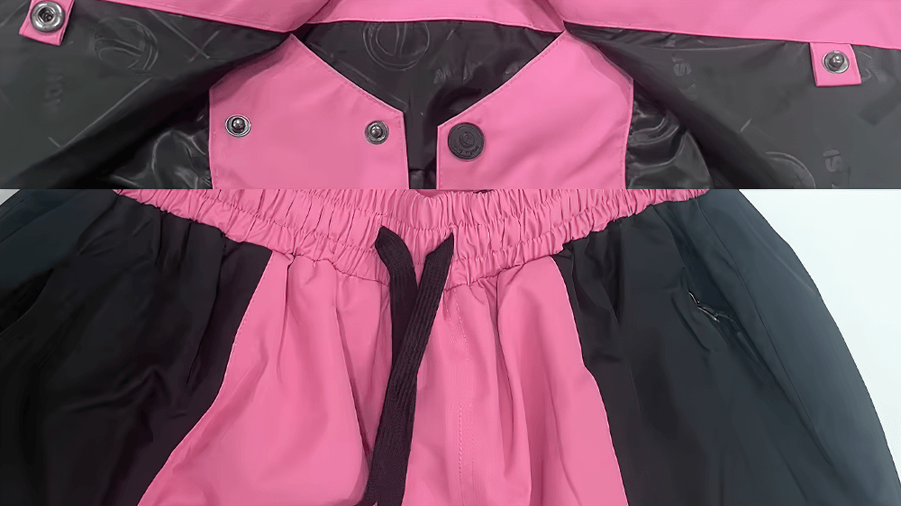 Close-up of pink and black waterproof snowboarding jacket and pants set with adjustable features for winter adventures.