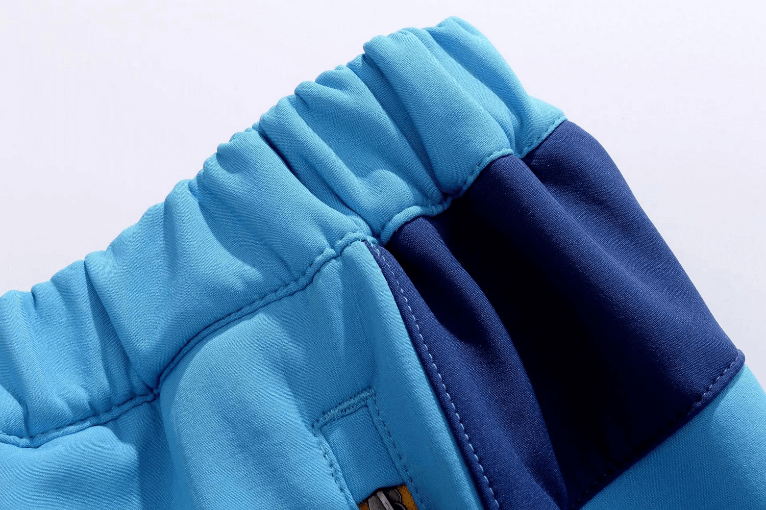 Close-up view of blue Waterproof Soft Shell Pants for Outdoor Activities - SF3778, highlighting stretch waistband and pocket.