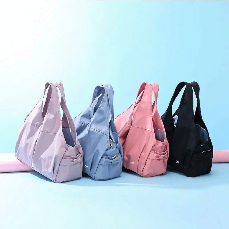 Four waterproof sports women's bags in pink, blue, lavender, and black, featuring multiple roomy pockets, perfect for an active lifestyle.