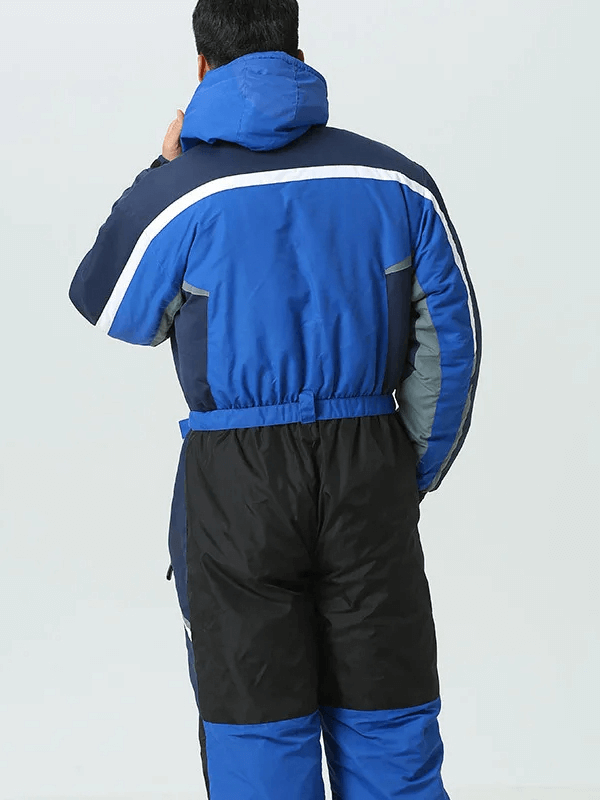 Man wearing blue waterproof ski jumpsuit with hood, perfect for snowboarding and skiing in cold, windy weather.