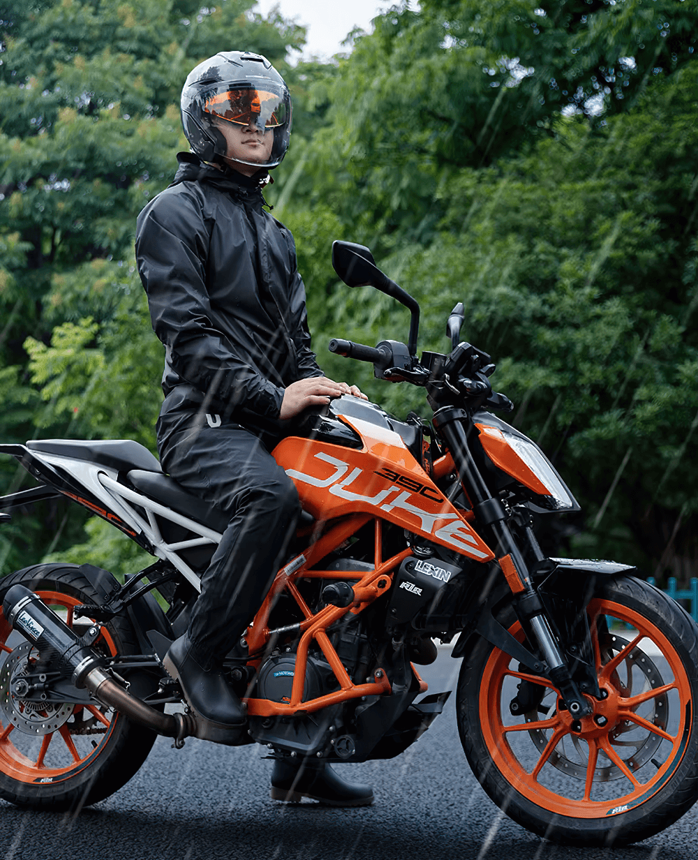 Rainy day motorcycle ride in waterproof gear, showcasing a rider on an orange bike, ready for adventure in wet conditions.