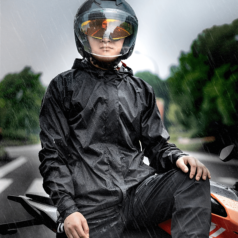 Waterproof windproof cycling jacket and pants set showcased on a rider in the rain, highlighting visibility and style.