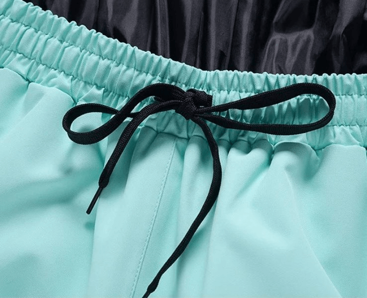 Close-up of mint green unisex waterproof windproof ski pants SF1825 with elastic waist and black drawstring.