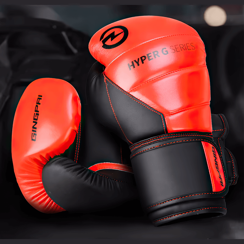 Vibrant red and black PU leather boxing gloves with secure wrist strap, perfect for sparring and combat sports training.
