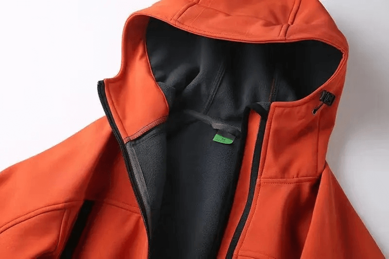 Orange weather-resistant softshell hooded jacket with black lining for outdoor activities, ideal for camping and hiking.